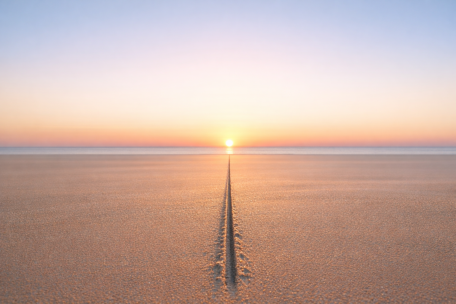 Minimalist image of a single straight line drawn across smooth sand leading toward a sunrise horizonNo people present. Soft morning light illuminates th-1